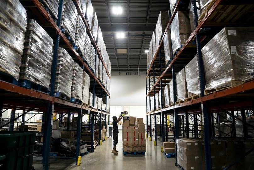 Person stacking boxes at Second Harvest Heartland. Photo credit: Renee Jones Schneider